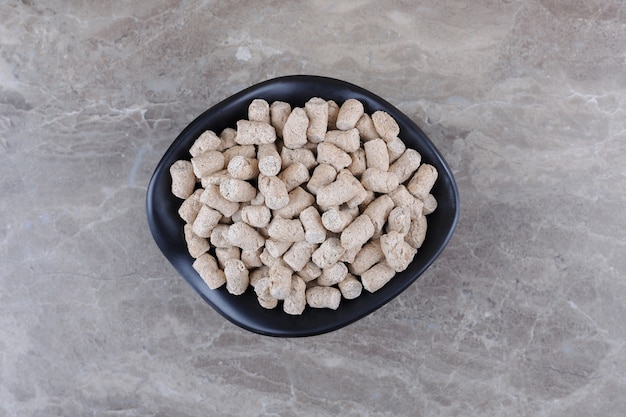 Bread crumbs in the bowl, on the marble background.