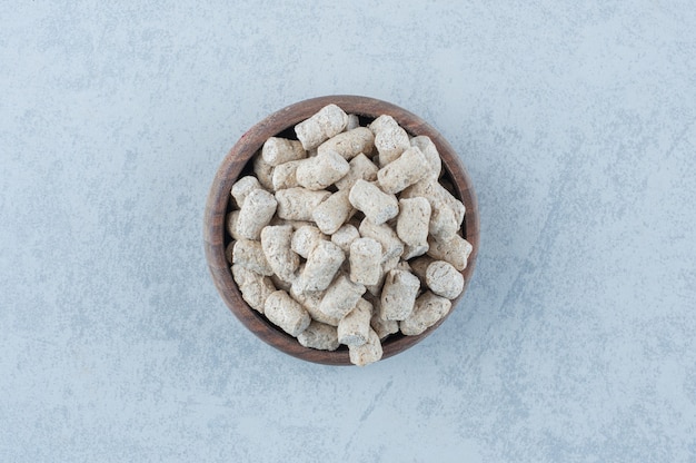 Free photo bread crumbs in the bowl next to spike on marble.