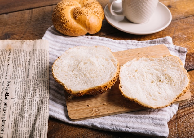 Bread cut into halved on chopping board over the napkin