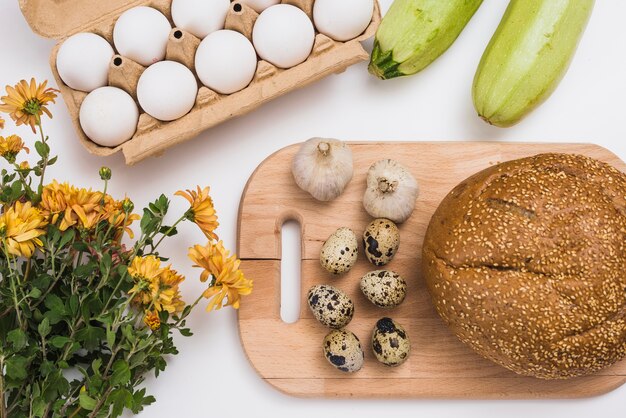 Bread and eggs on wooden board