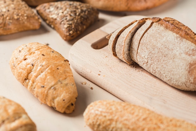 Bread loaf on chopping board over the table