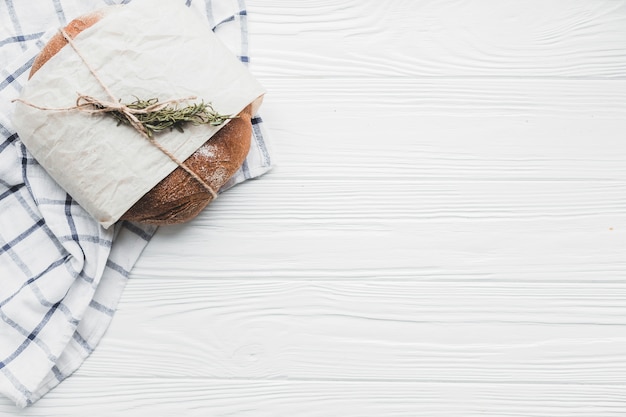 Free photo bread loaf in parchment paper