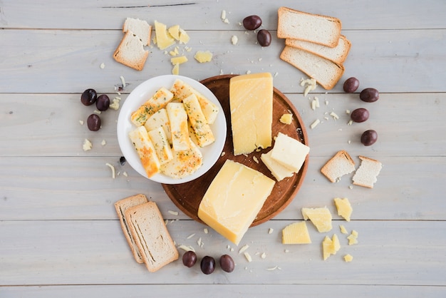 Bread; olives with cheese chunk for breakfast on table