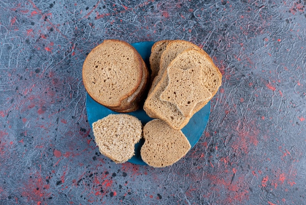 Bread slices isolated in a blue platter. 