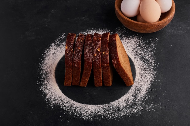 Bread slices with flour and eggs around. 