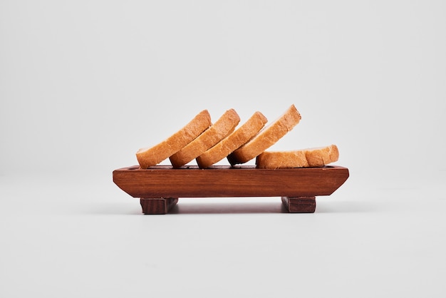 Bread slices on wooden board.