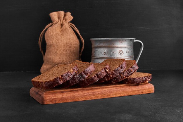 Bread slices on a wooden platter. 