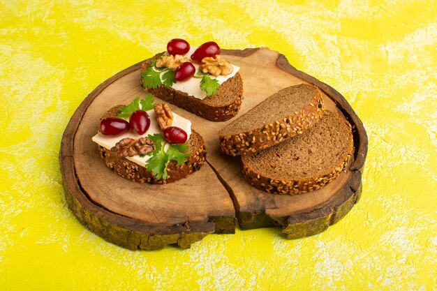bread toasts with cheese walnuts and dogwood on yellow