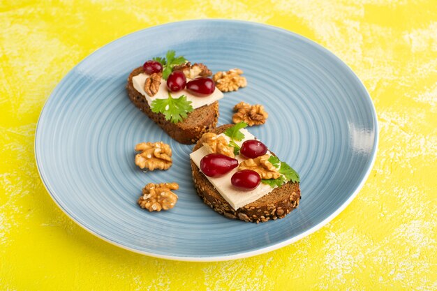 bread toasts with cheese and walnuts inside blue plate on yellow