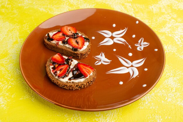 bread toasts with sour cream and strawberries inside brown plate on yellow