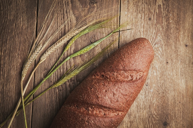 Bread and wheat on a wooden. flat lay.