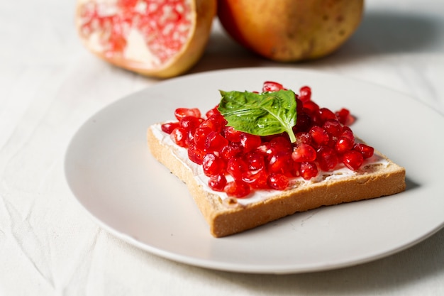 Bread with butter and pomegranate seeds