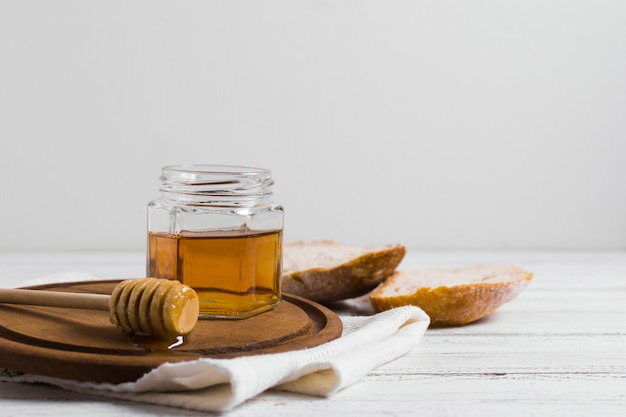 Bread with honey on wooden board