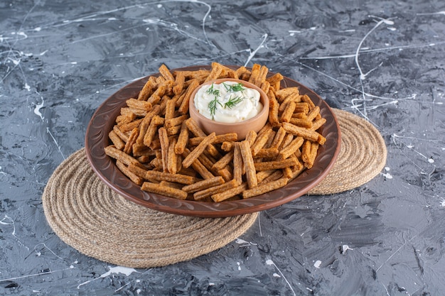 Breadcrumbs and yogurt in wooden plate on trivet , on the marble surface