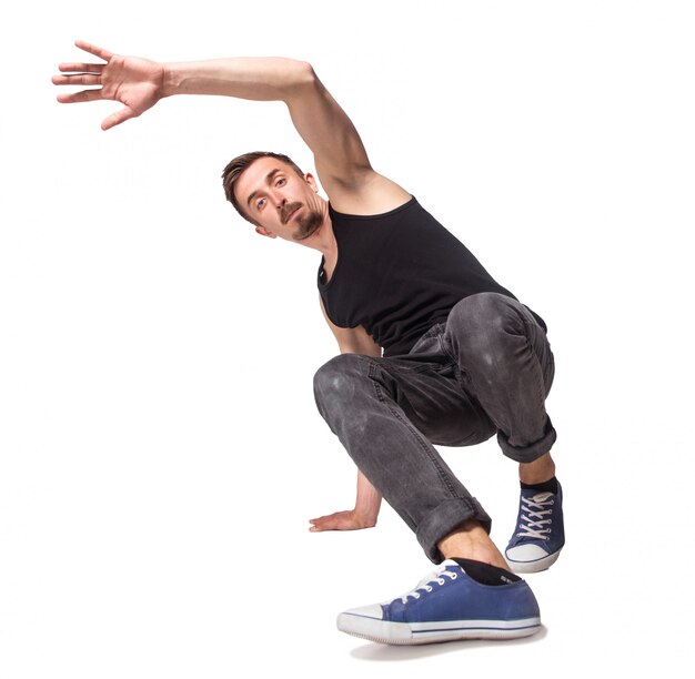 Break dancer doing one handed handstand against a white background