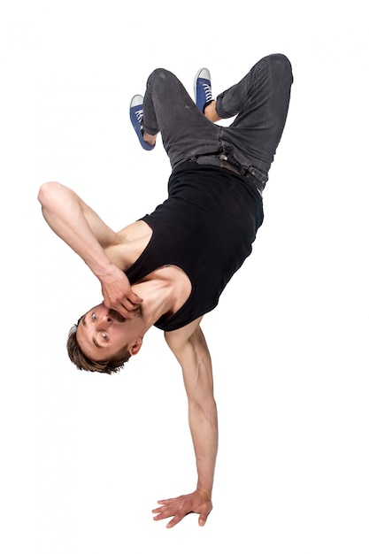 Free photo break dancer doing one handed handstand against a white background