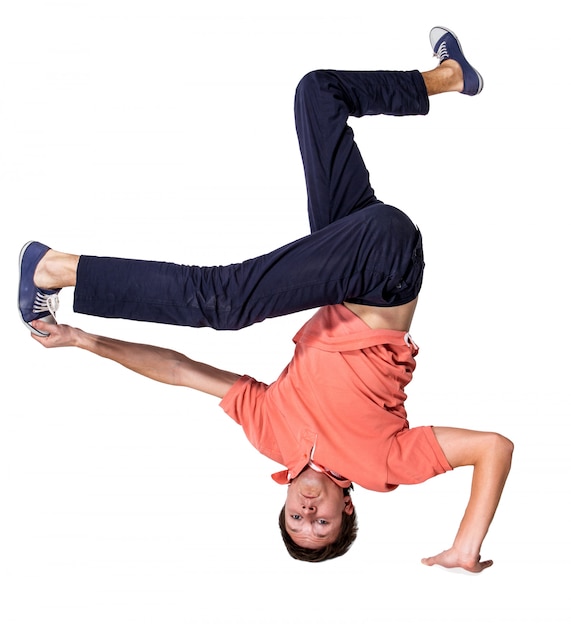 Break dancer doing one handed handstand against a white background