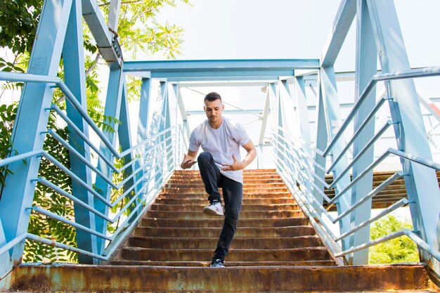 Breakdancer posing on staircase