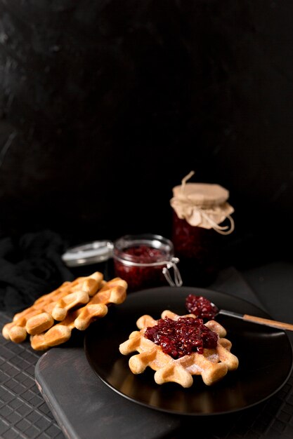 Breakfast arrangement waffles and raspberry jam high view