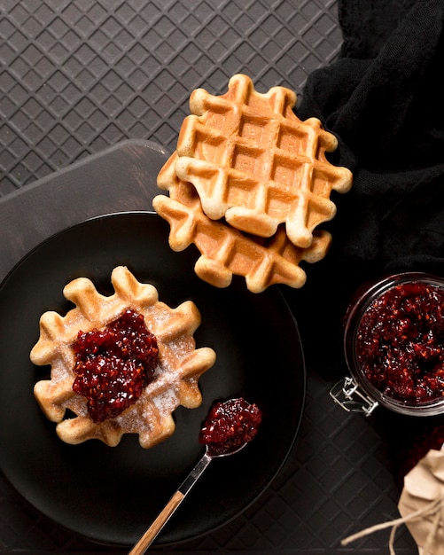 Free photo breakfast arrangement waffles and raspberry jam