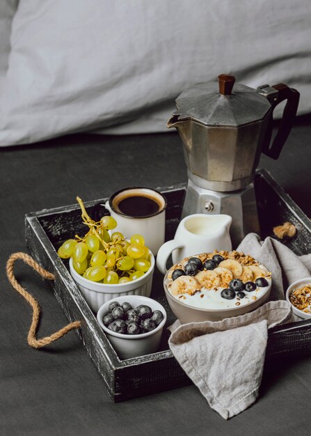 Breakfast in bed with blueberries and cereal on tray