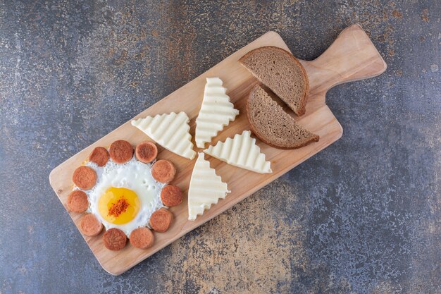 Breakfast board with egg, sausage and bread