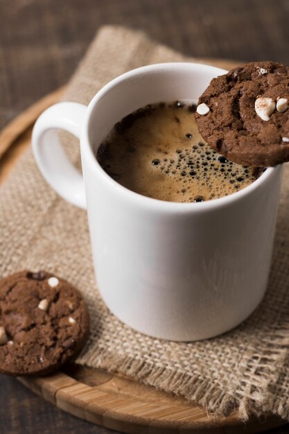 Breakfast coffee in white mug and cookies high view