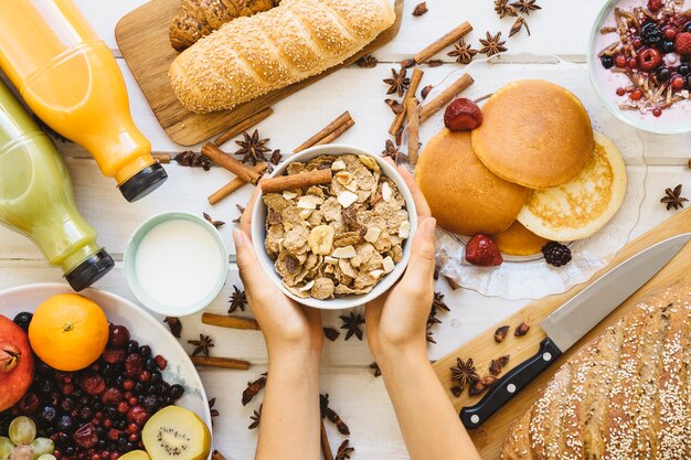 Breakfast decoration with hands holding cereals