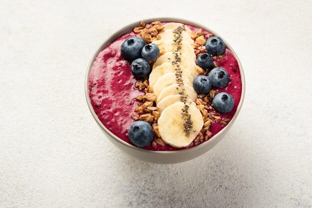 Breakfast dessert in bowl with banana slices and blueberries