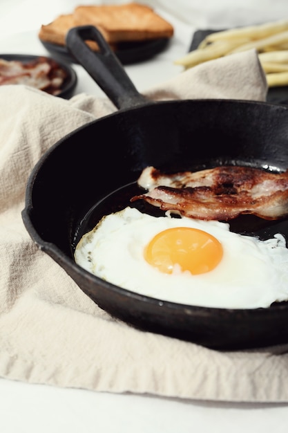 Breakfast of eggs and fried bacon in the pan