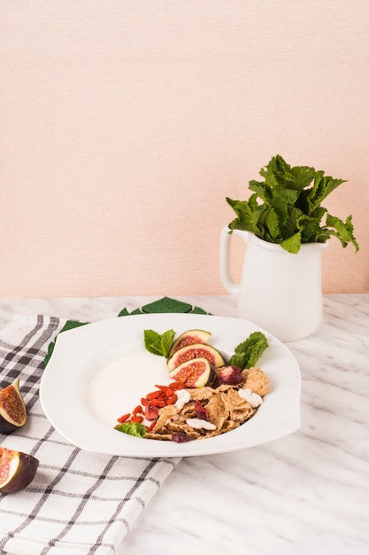 흰색 대리석에 민트 잎과 부엌 냅킨의 용기와 아침 식사 접시
