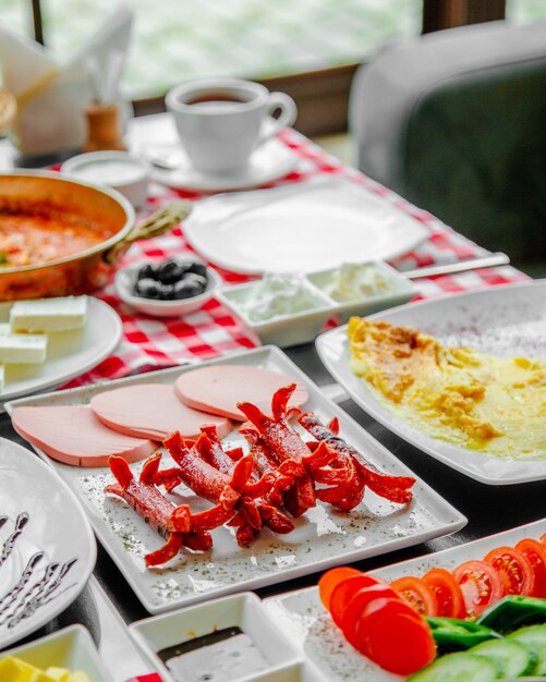 Breakfast table with sausages and ham.