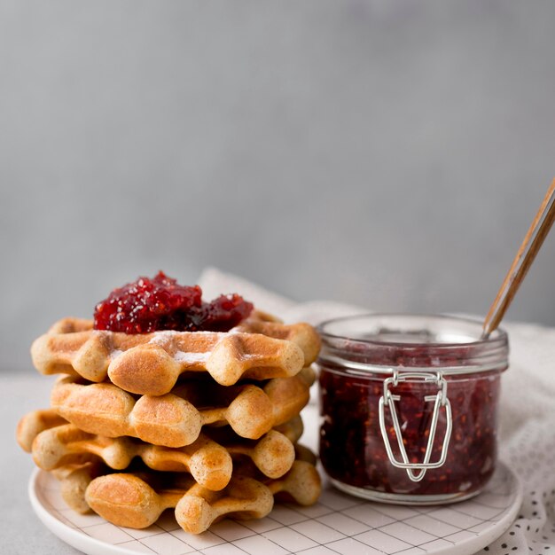 Breakfast waffles and raspberry jam front view