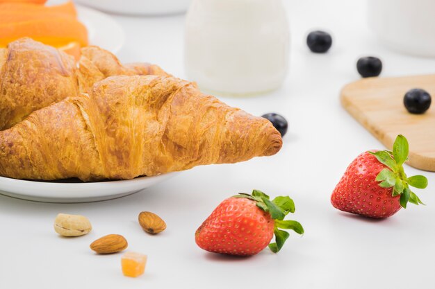 Breakfast with croissants and fruits