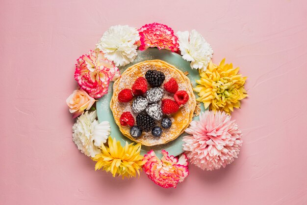 Breakfast with flowers and pink background