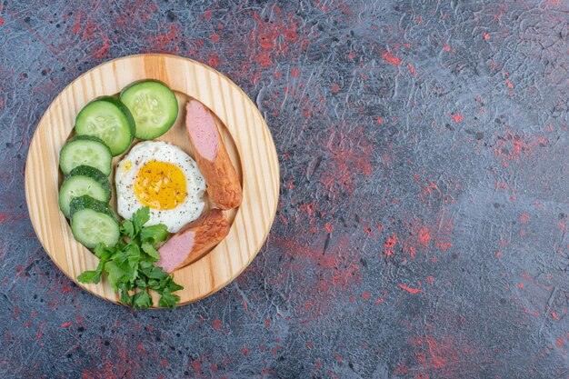 Breakfast with fried egg and sausages. 