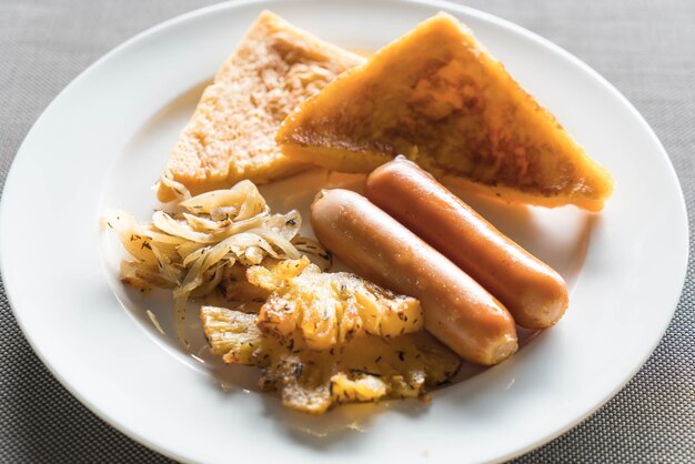 breakfast with fried pineapples, sausages and toasts