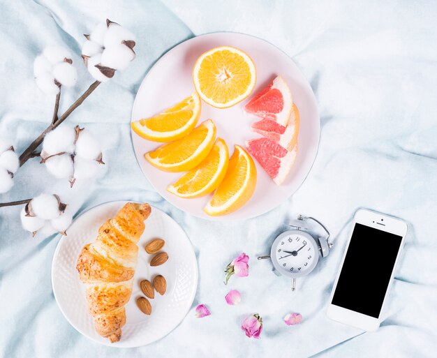 Breakfast with fruits and mobile phone