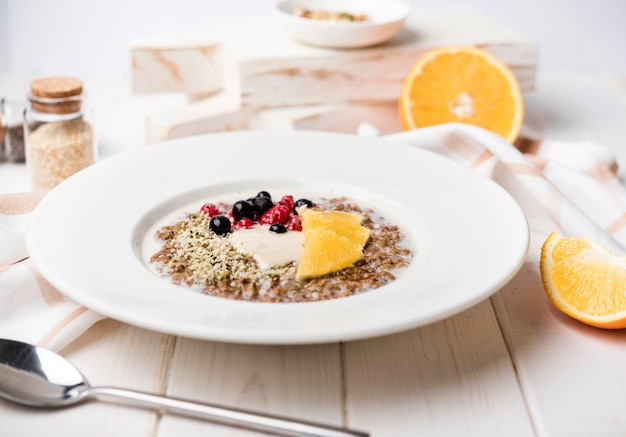 Breakfast with orange slices and seeds front view