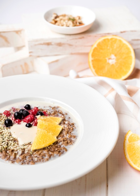 Free photo breakfast with orange slices and seeds high view