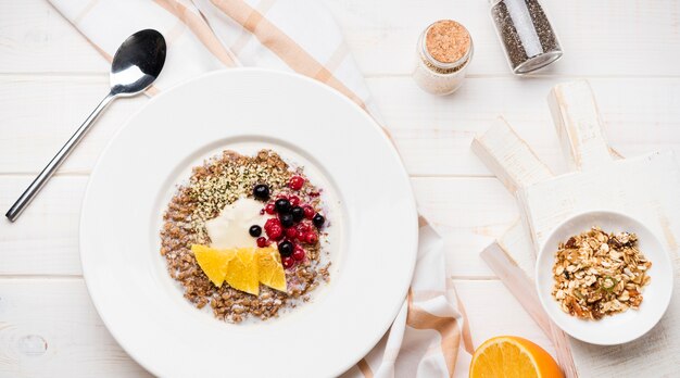 Breakfast with orange slices and seeds top view