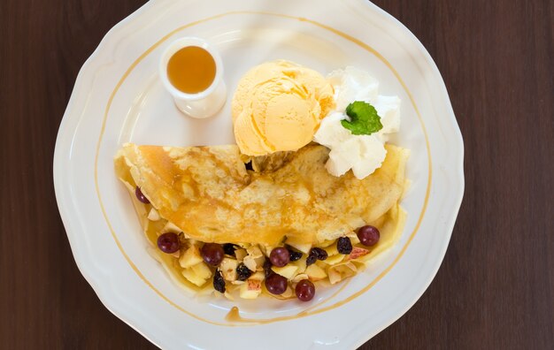 Breakfast with pancakes and bread seen from above