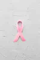 Free photo breast cancer ribbon on plaster background