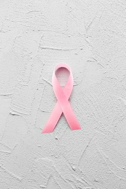 Breast cancer ribbon on plaster background