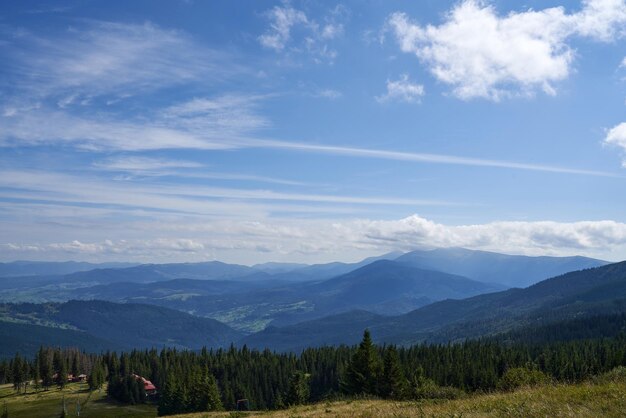 Breathtaking landscape of mountains with single houses in dense forest outdoor