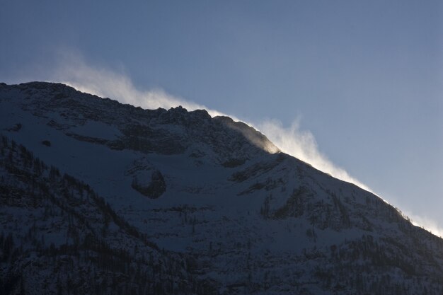 Breathtaking scenery of the snow-capped mountains under a scenic cloudy sky