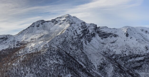 Breathtaking shot of the Ancares mountains covered with snow glimmering under the blue sky