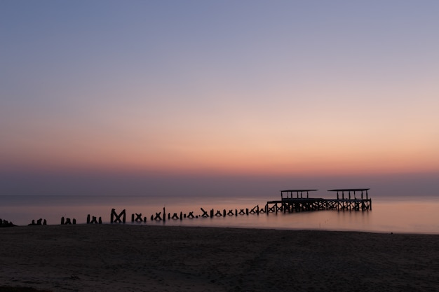 Breathtaking view of a broken wooden dock on the ocean captured in Thailand