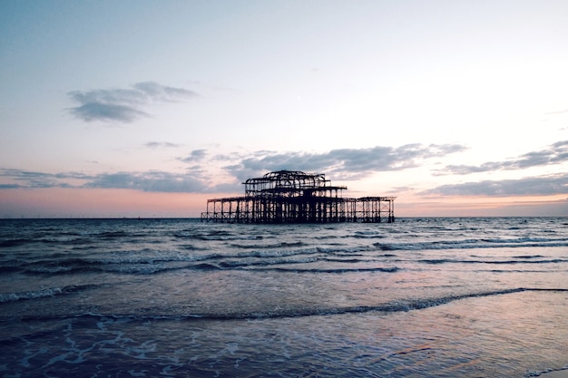 Free photo breathtaking view of a calm sea under a cloudy sky at sunset