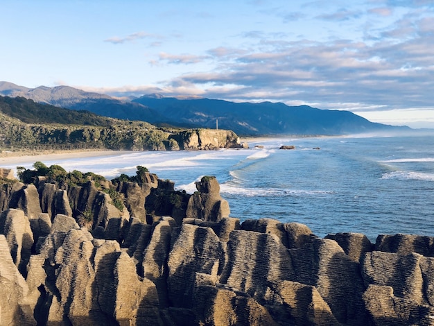 Free photo breathtaking view of the sea, rocky shore, and a blue horizon